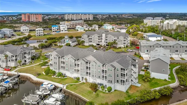 an aerial view of residential houses with outdoor space