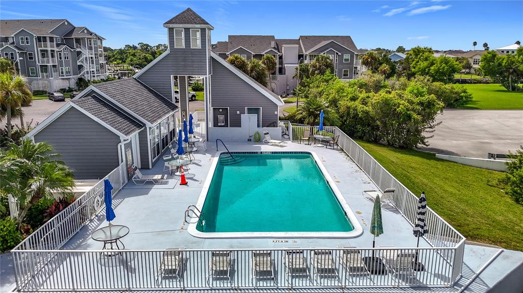 5722 Biscayne Court, Unit 103 New Port Richey, FL 34652 - Photo 52 of 99 an aerial view of a house with swimming pool garden and mountain view