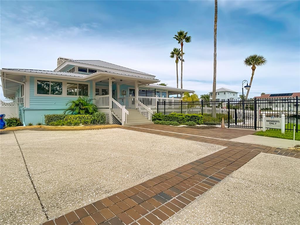 5722 Biscayne Court, Unit 103 New Port Richey, FL 34652 - Photo 58 of 99 a view of a house with a yard and potted plants