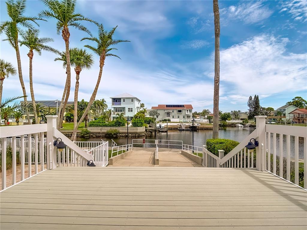 5722 Biscayne Court, Unit 103 New Port Richey, FL 34652 - Photo 60 of 99 a view of a lake with boats and palm trees
