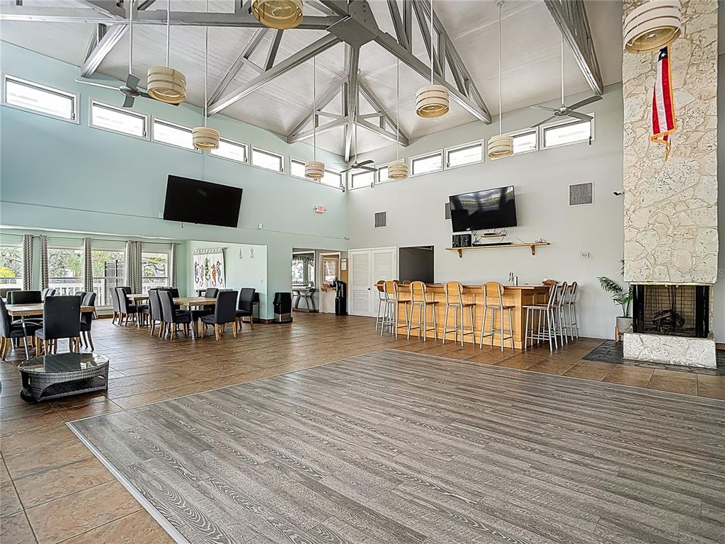 5722 Biscayne Court, Unit 103 New Port Richey, FL 34652 - Photo 65 of 99 a living room with furniture and flat screen tv