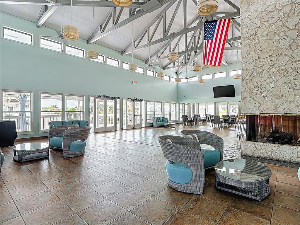 5722 Biscayne Court, Unit 103 New Port Richey, FL 34652 - Photo 66 of 99 a living room with furniture and a flat screen tv