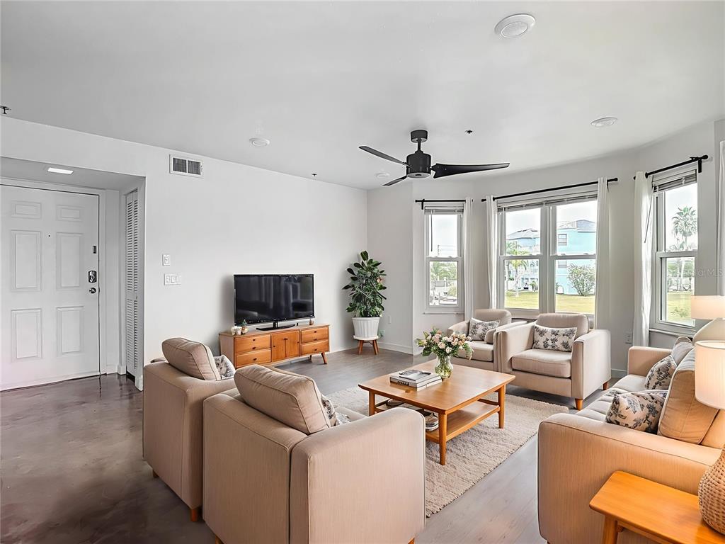 5722 Biscayne Court, Unit 103 New Port Richey, FL 34652 - Photo 8 of 99 a living room with furniture and a flat screen tv