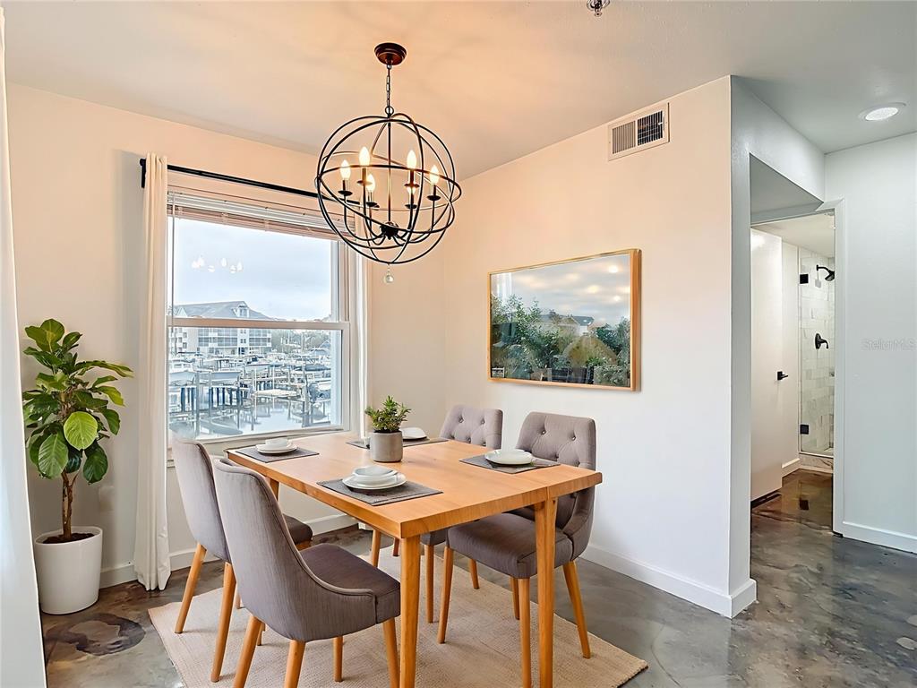5722 Biscayne Court, Unit 103 New Port Richey, FL 34652 - Photo 9 of 99 a view of a dining room with furniture window and wooden floor