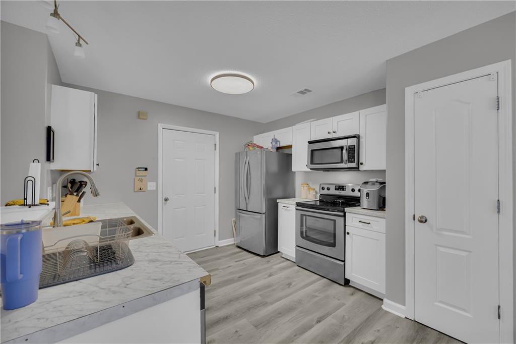 1498 Box Circle Winder, GA 30680 - Photo 20 of 56 a kitchen with stainless steel appliances granite countertop a stove a sink and a refrigerator
