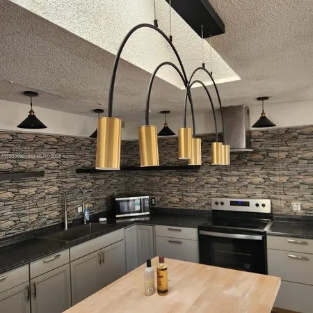 a kitchen with sink and cabinets