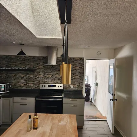 a kitchen with stainless steel appliances granite countertop a stove and a refrigerator