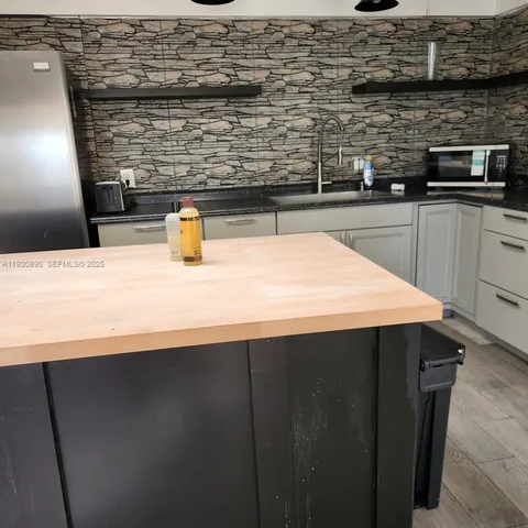 a kitchen with a sink and a refrigerator