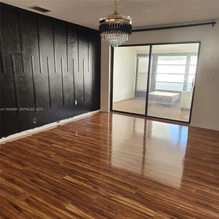 a view of a room with wooden floor