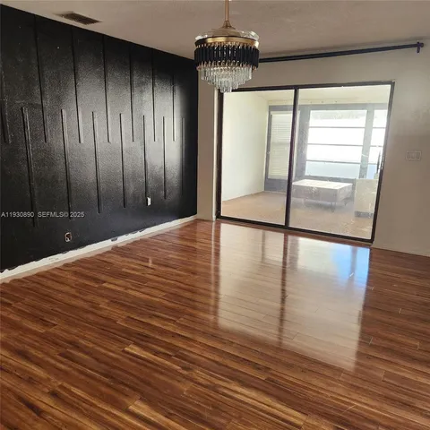 a view of a room with wooden floor