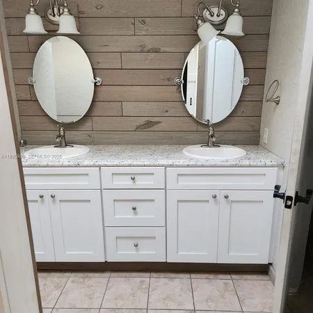 a bathroom with a sink vanity and mirror