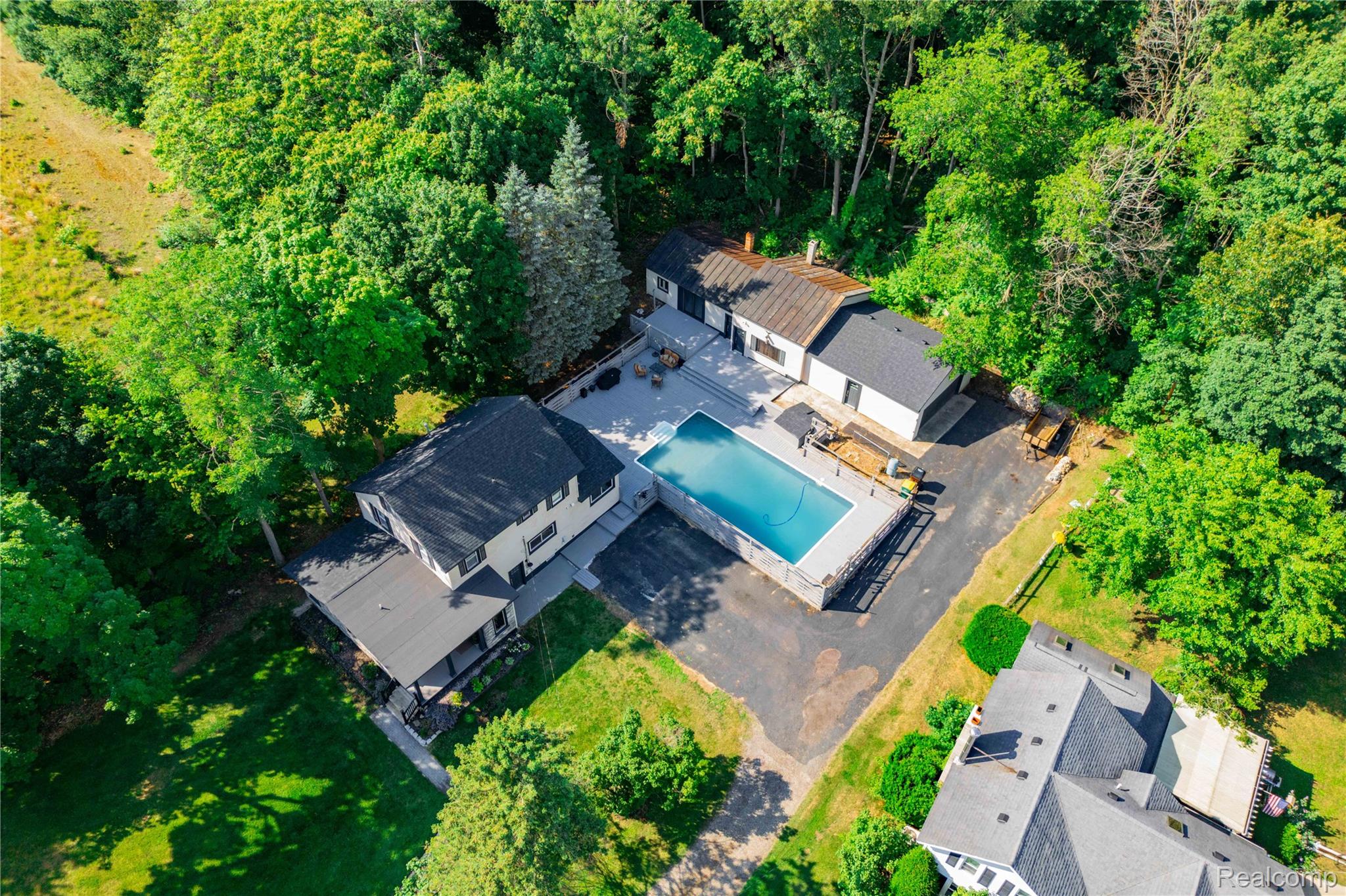 4860 Blue Bush Road Monroe, MI 48162 - Photo 52 of 59 Aerial property overview featuring a main residence, detached ancillary building, in-ground swimming pool, and extensive surrounding greenery