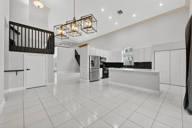 a kitchen with a refrigerator and a sink