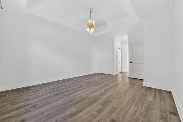 a view of a room with wooden floor and window