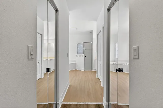 a bathroom with a granite countertop sink a toilet a mirror and shower