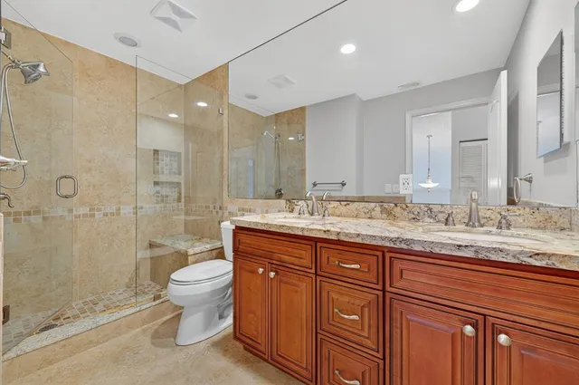 an aerial view of a house with yard and swimming pool