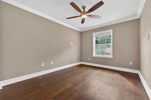 an aerial view of residential houses with outdoor space and trees