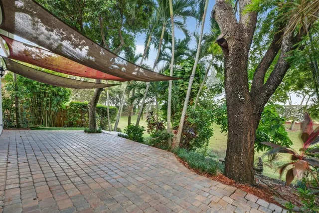 an aerial view of a house with a yard and lake view