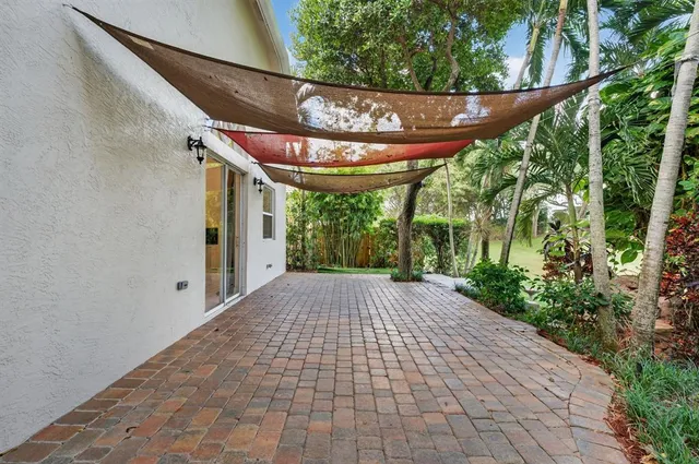 an aerial view of a house with a yard and trees