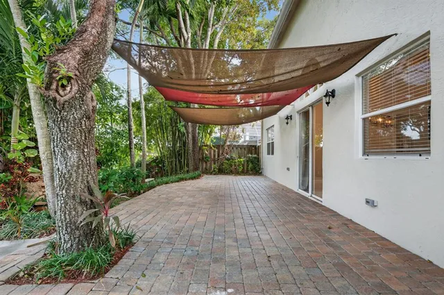 an aerial view of a house with a yard and lake view