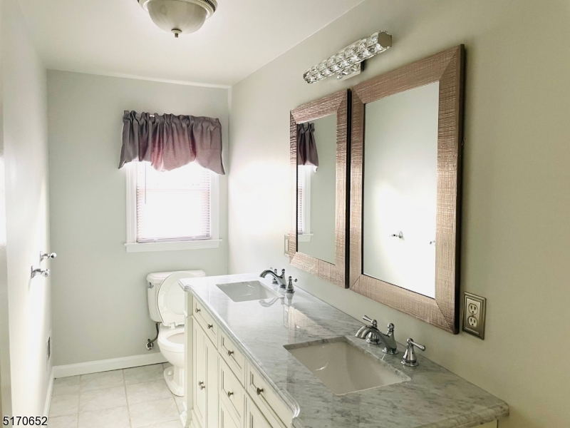57 Russell Avenue Rahway, NJ 07065 - Photo 11 of 20 a bathroom with a granite countertop sink toilet and mirror