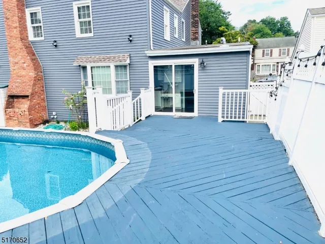 a view of a balcony with wooden floor and fence