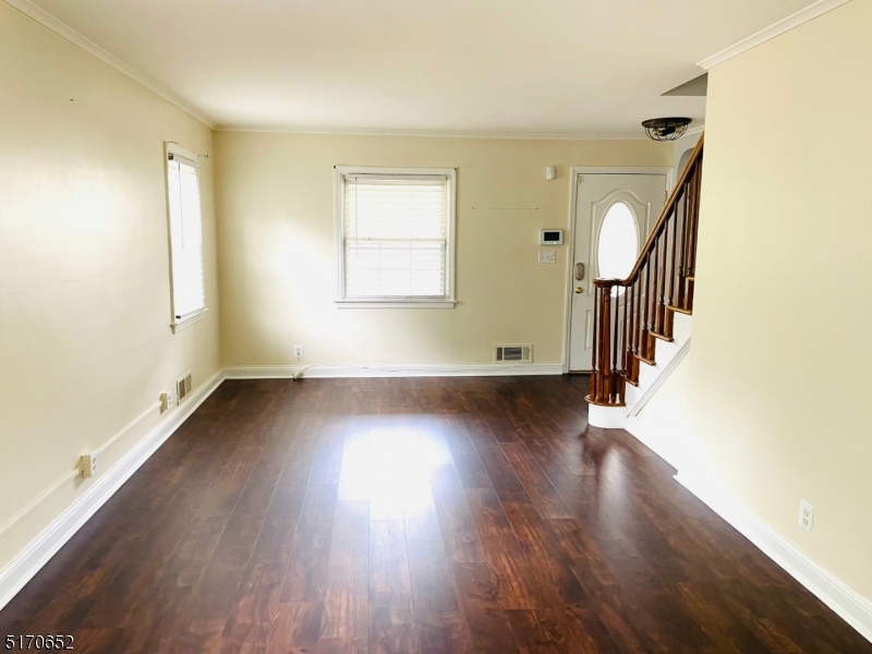 57 Russell Avenue Rahway, NJ 07065 - Photo 4 of 20 a view of a room with wooden floor and staircase