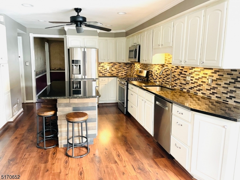 57 Russell Avenue Rahway, NJ 07065 - Photo 5 of 20 a kitchen with stainless steel appliances kitchen island granite countertop a sink and cabinets