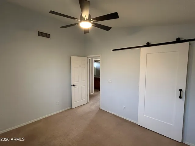 a view of an empty room with a fan
