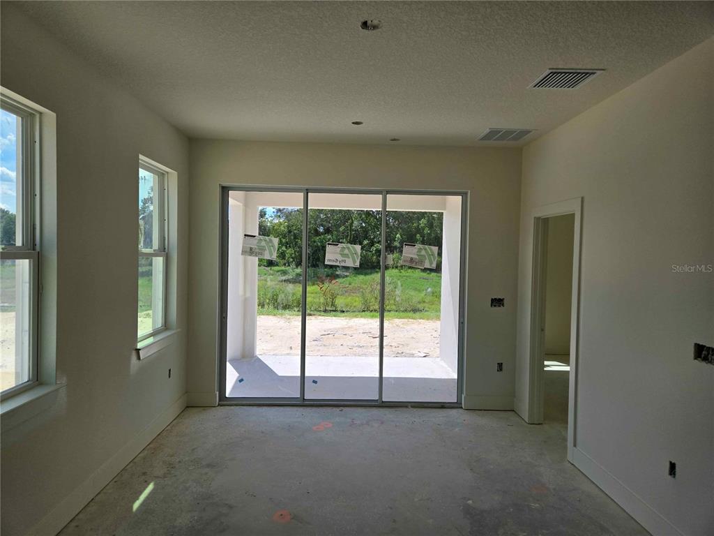 3844 Daybreak Run Loop Spring Hill, FL 34609 - Photo 4 of 11 a view of an empty room with a window