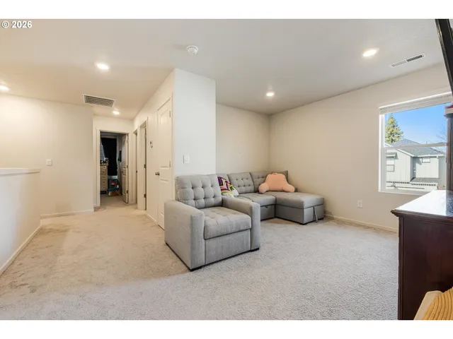 a living room with furniture and a walk in closet