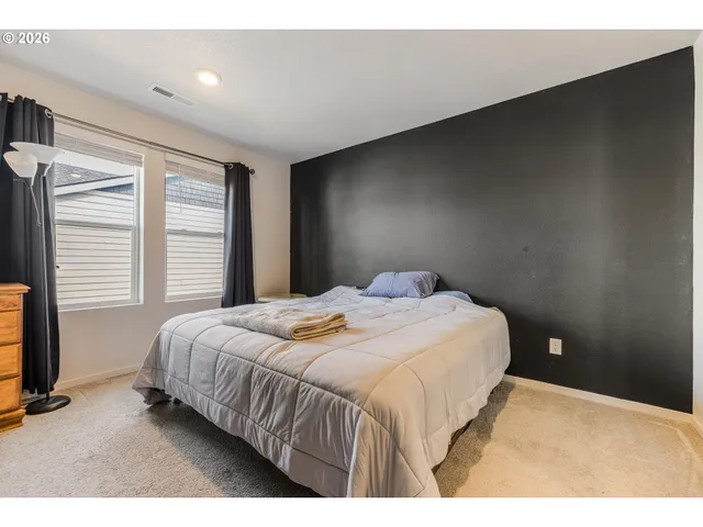 a bedroom with a bed and a night stand