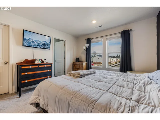 a bedroom with a bed and a dresser