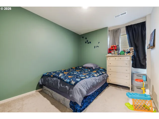 a bedroom with a bed and a dresser