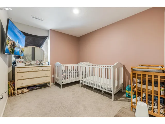 a view of a bedroom with furniture and windows