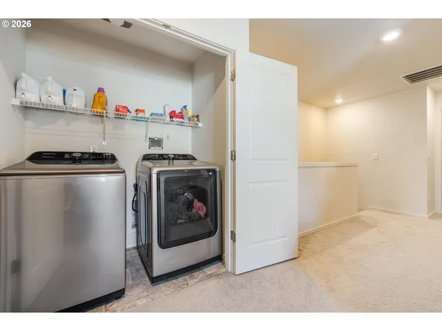 a utility room with washer and dryer