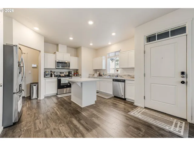 a open kitchen with cabinets and stainless steel appliances
