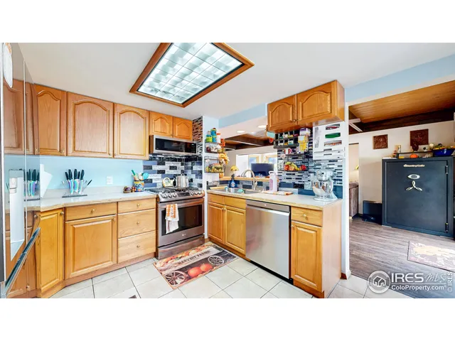 a bedroom with a bed and a flat tv screen on dresser