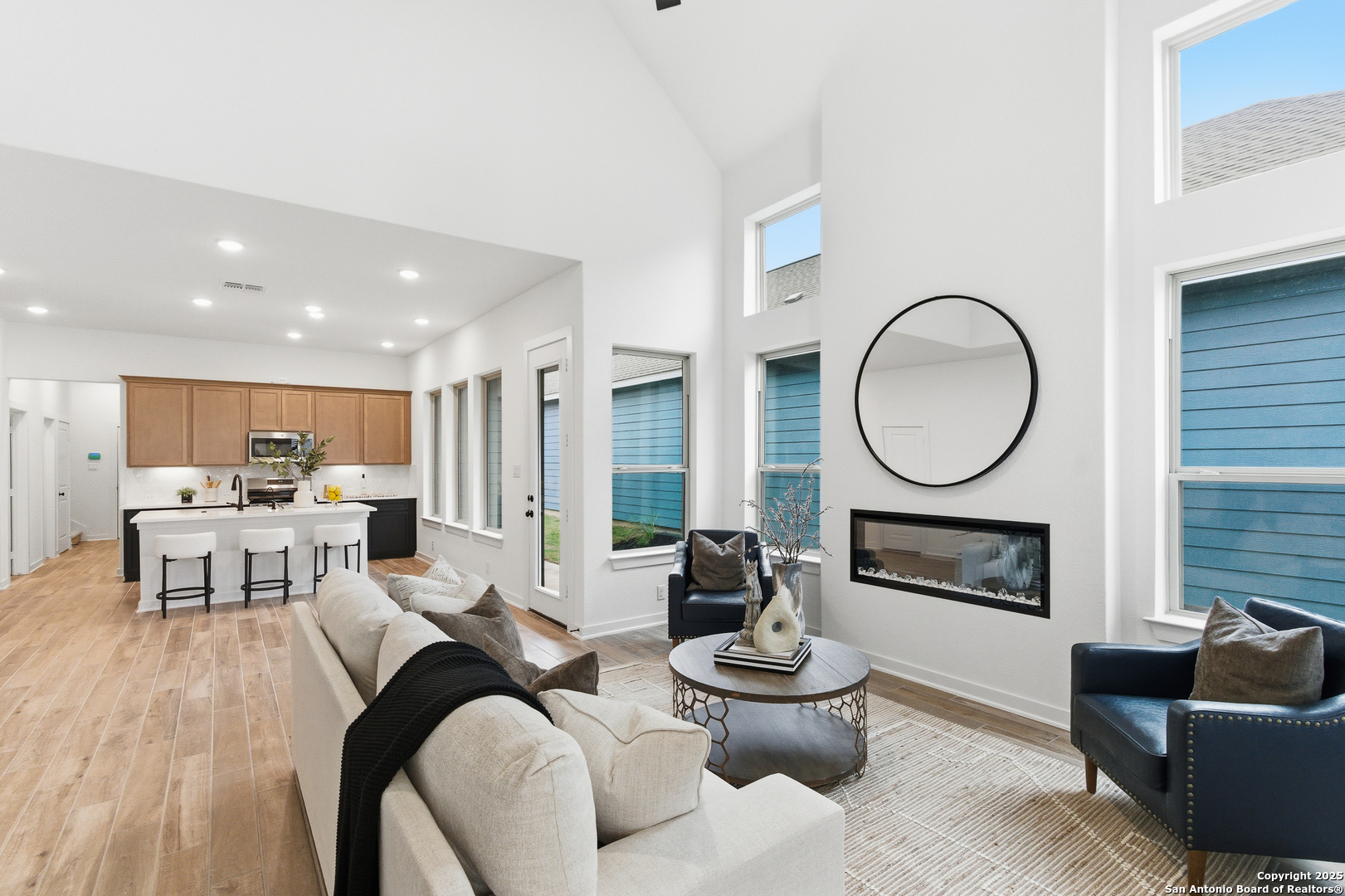 9426 Chatside Schertz, TX 78154 - Photo 18 of 44 a living room with furniture a fireplace a rug and a large window