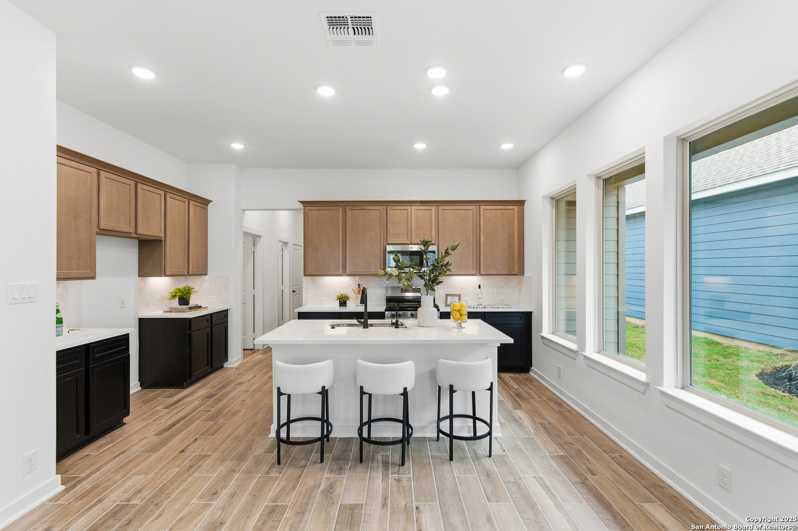 9426 Chatside Schertz, TX 78154 - Photo 22 of 44 a kitchen with stainless steel appliances a dining table chairs stove refrigerator and cabinets