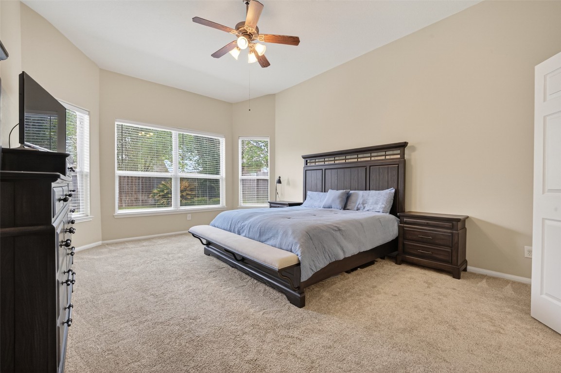 3219 Legends Mist Drive Spring, TX 77386 - Photo 26 of 50 a bedroom with a bed flat screen tv and a large window