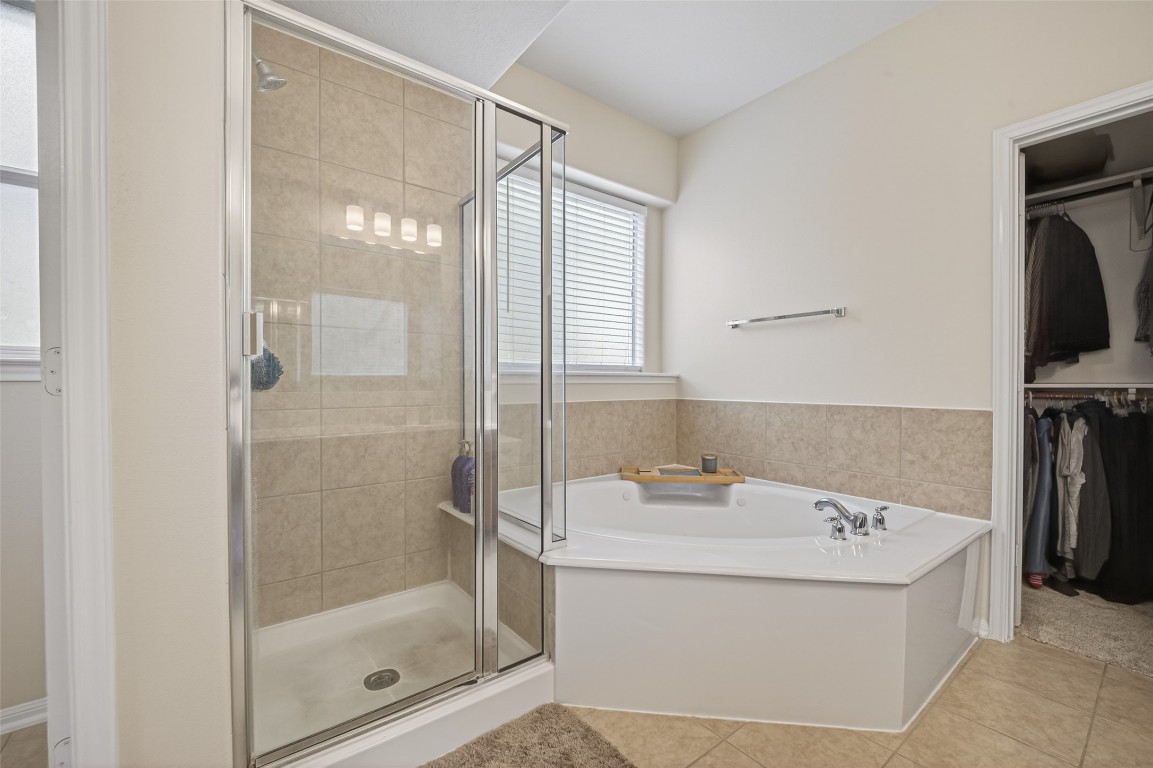 3219 Legends Mist Drive Spring, TX 77386 - Photo 30 of 50 a bathroom with a tub sink and mirror