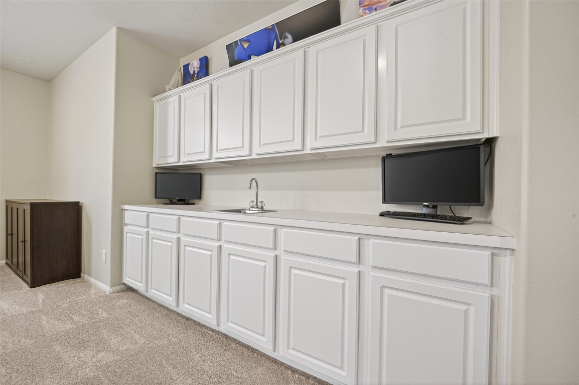 3219 Legends Mist Drive Spring, TX 77386 - Photo 35 of 50 a kitchen with white cabinets and a sink