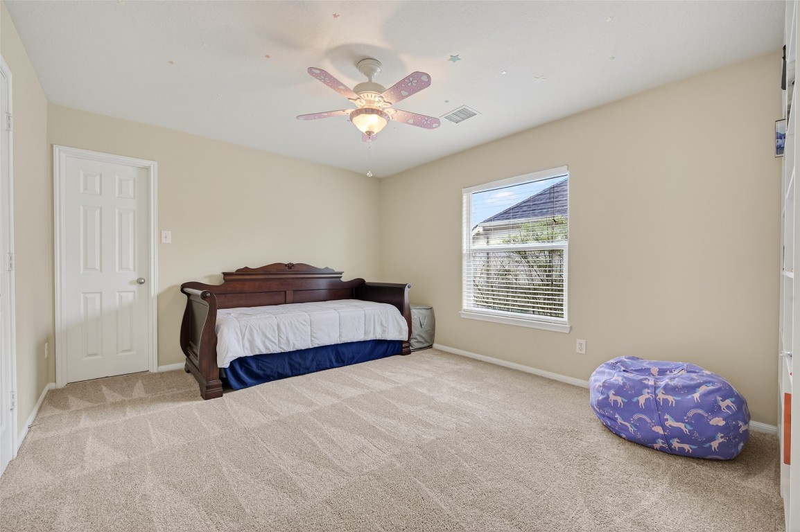 3219 Legends Mist Drive Spring, TX 77386 - Photo 36 of 50 a bedroom with a bed and a chandelier