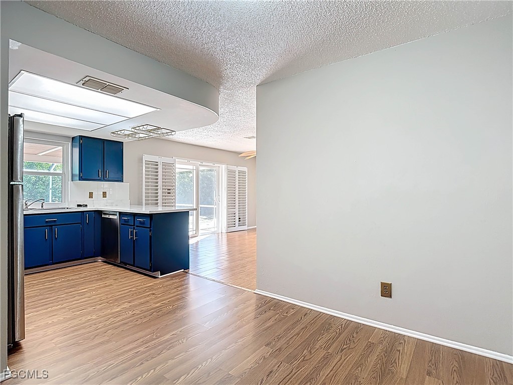 5946 Stringfellow Road St. James City, FL 33956 - Photo 13 of 50 a view of kitchen with wooden floor