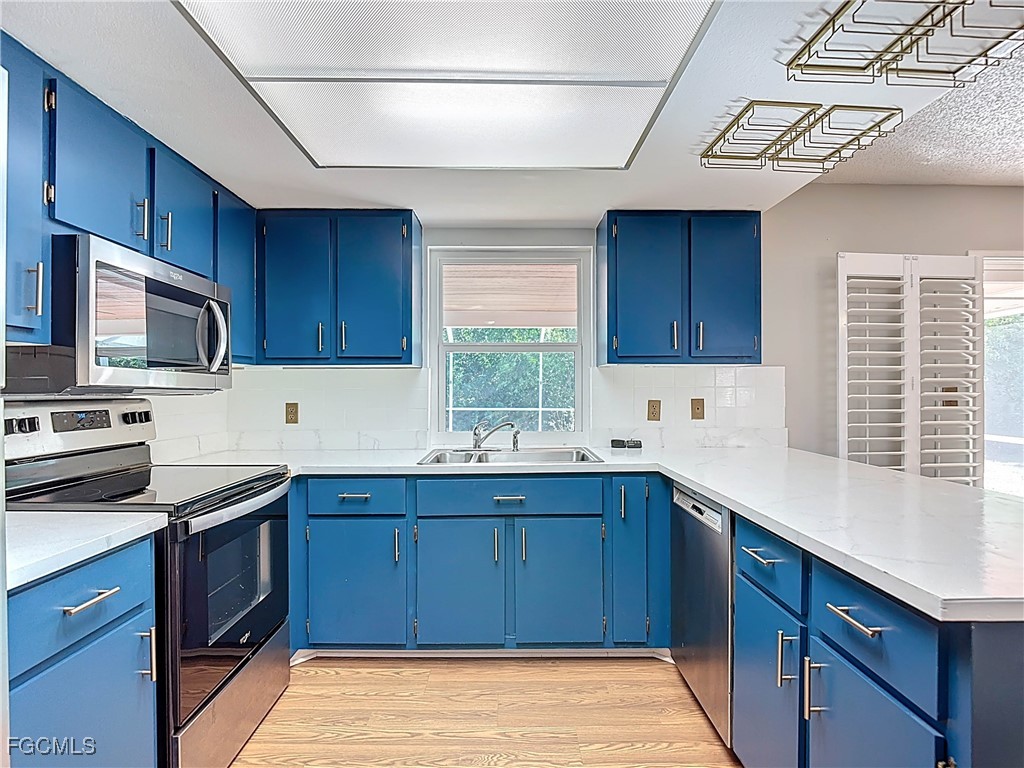 5946 Stringfellow Road St. James City, FL 33956 - Photo 18 of 50 a kitchen with a sink stove and microwave