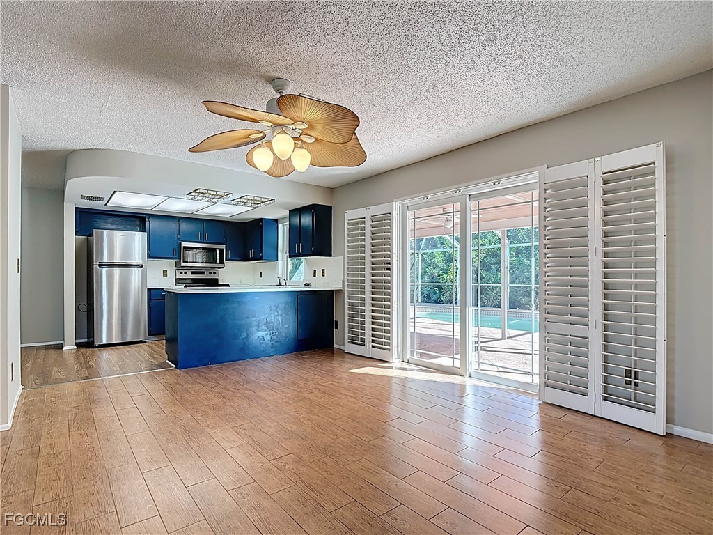 5946 Stringfellow Road St. James City, FL 33956 - Photo 23 of 50 a view of kitchen with wooden floor and window