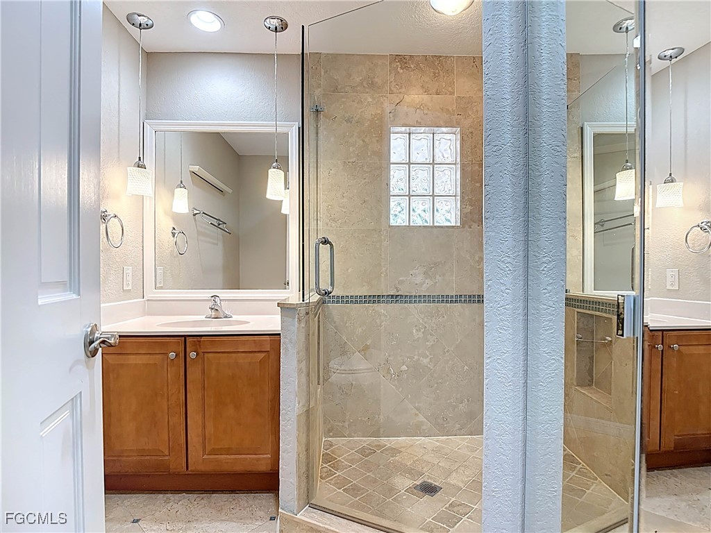 5946 Stringfellow Road St. James City, FL 33956 - Photo 28 of 50 a bathroom with a bathtub and a sink