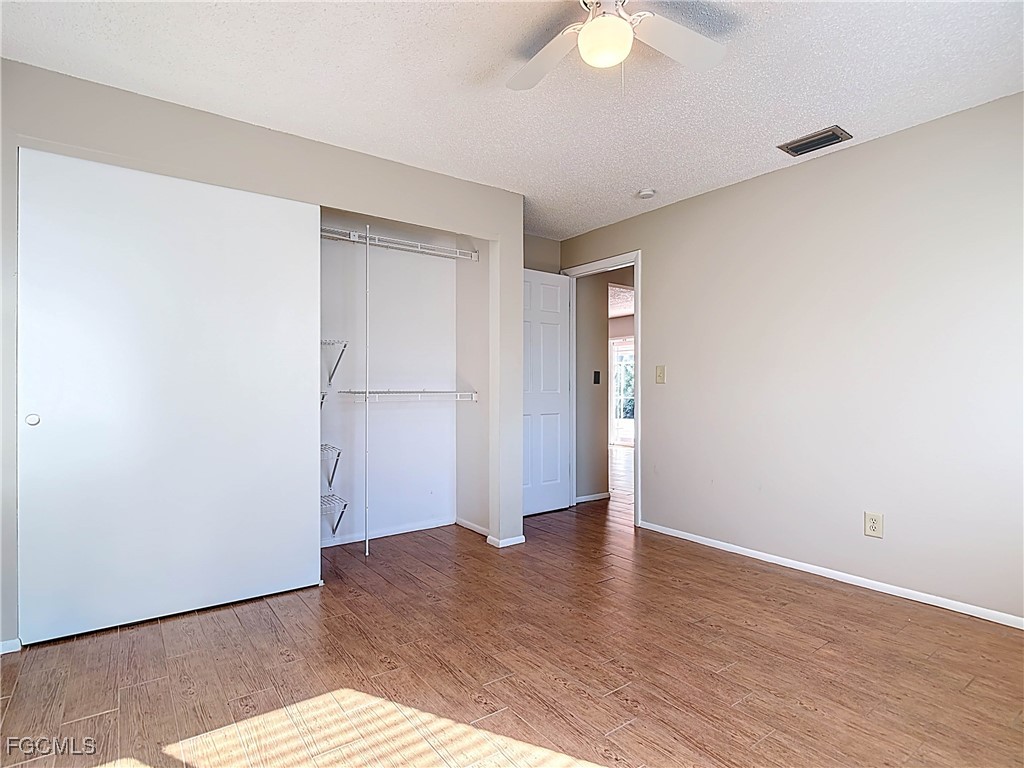 5946 Stringfellow Road St. James City, FL 33956 - Photo 32 of 50 a view of an empty room with wooden floor