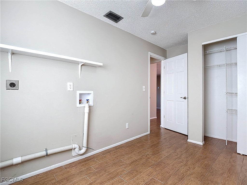 5946 Stringfellow Road St. James City, FL 33956 - Photo 36 of 50 an empty room with wooden floor and ceiling fan